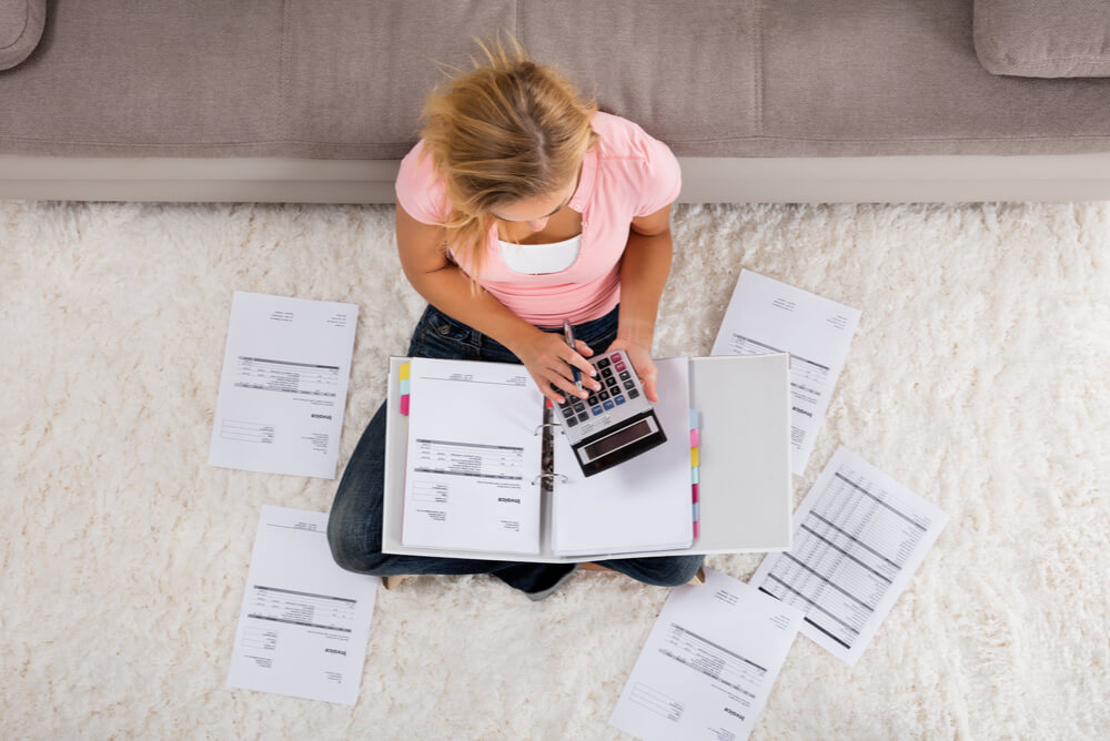 a woman looking at household bills to compare electricity and gas
